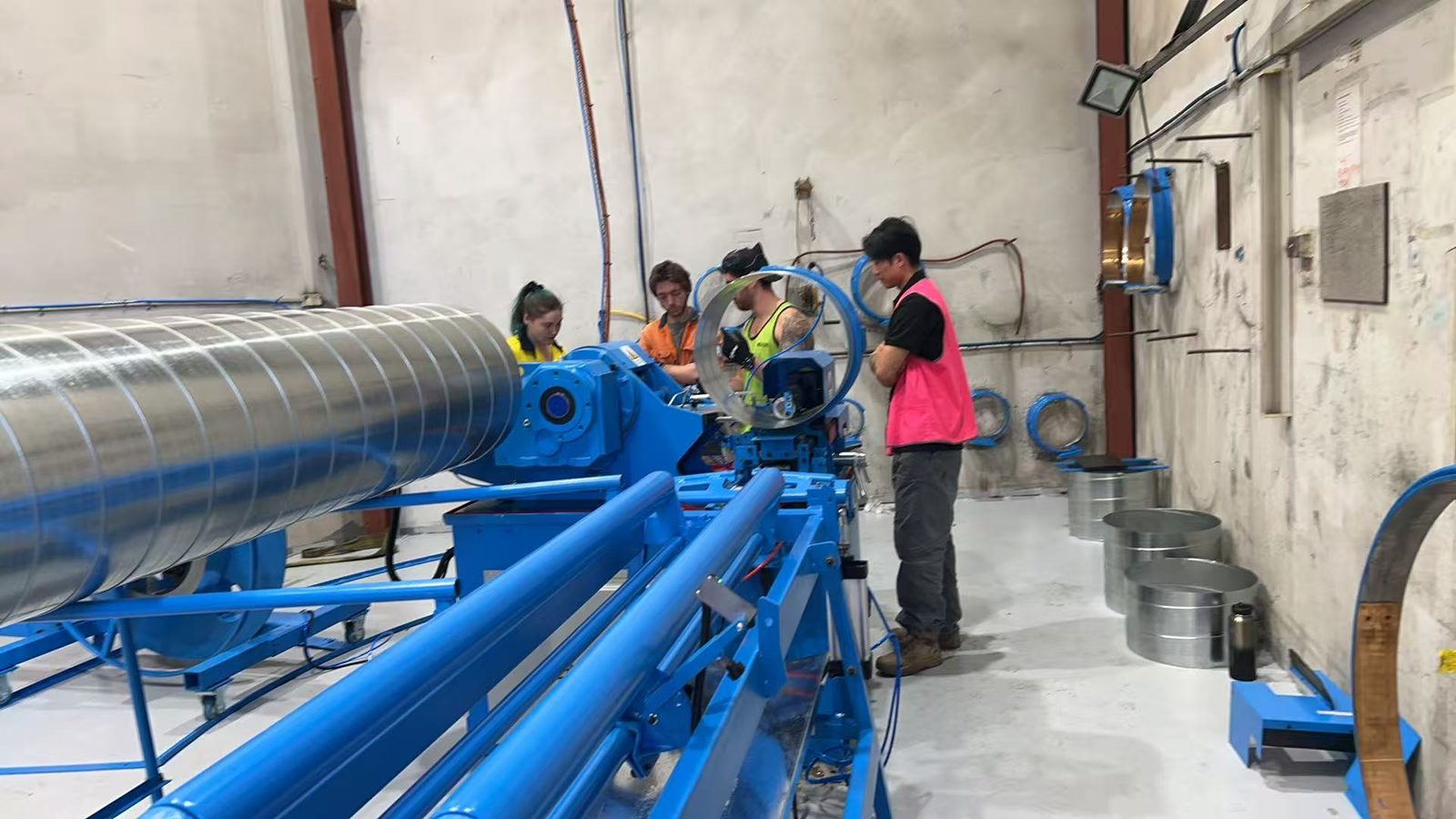 Kavanagh Industries operators working on the SBTF-1602 spiral head with a Taokron engineer